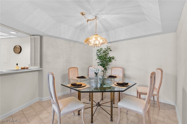 dining area with a textured ceiling and a chandelier