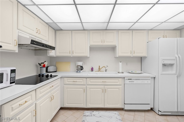 kitchen with a paneled ceiling, white appliances, white cabinetry, and sink