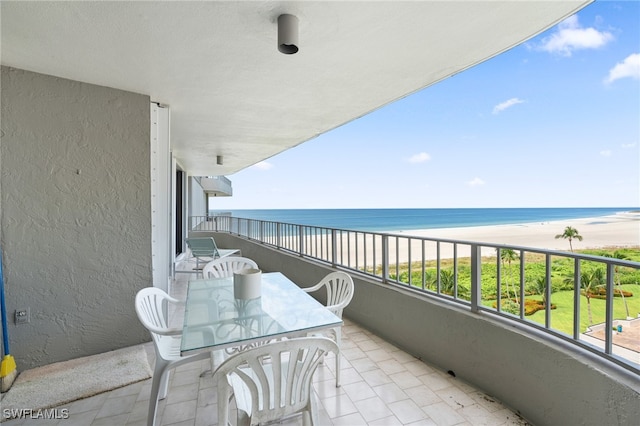 balcony featuring a water view and a beach view