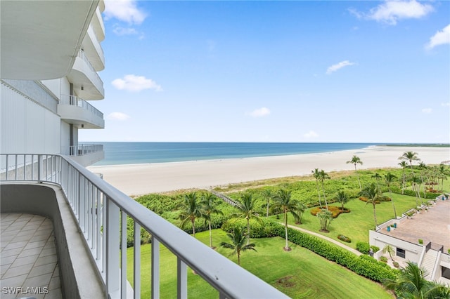 balcony featuring a beach view and a water view