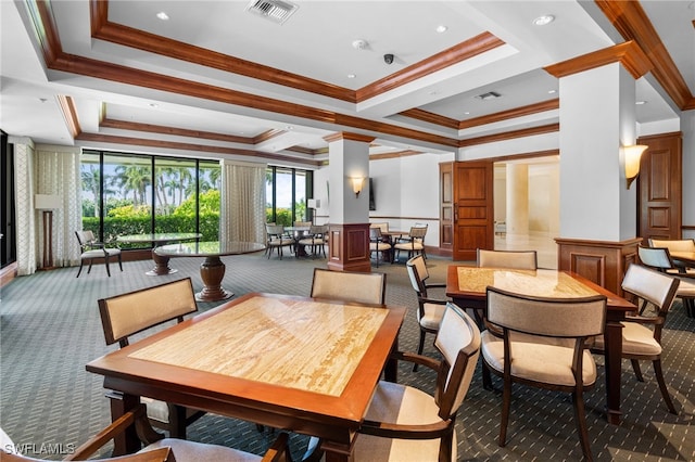 carpeted dining room featuring a tray ceiling and crown molding