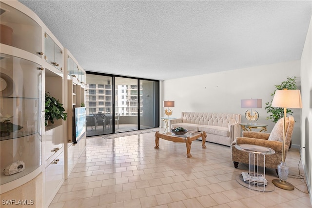 interior space with a textured ceiling, light tile patterned flooring, and expansive windows