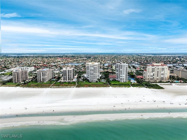 birds eye view of property featuring a water view and a view of the beach