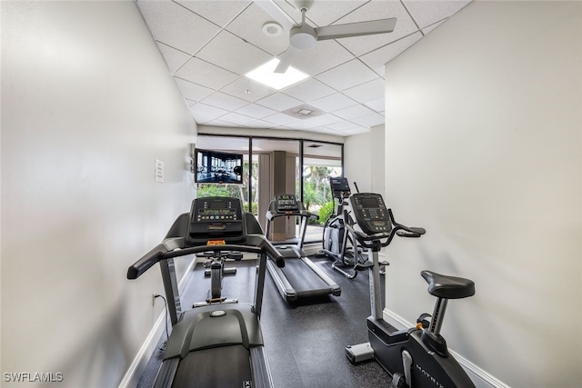 exercise area with a drop ceiling and ceiling fan