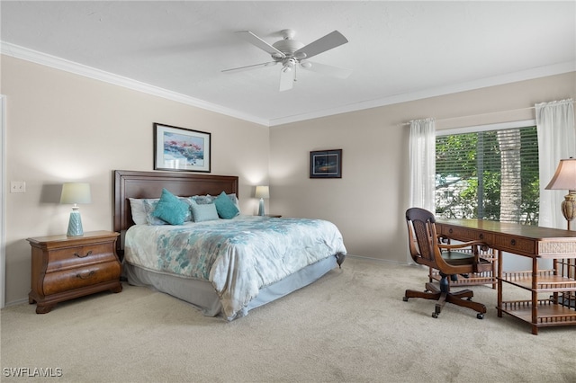 carpeted bedroom with ceiling fan and ornamental molding