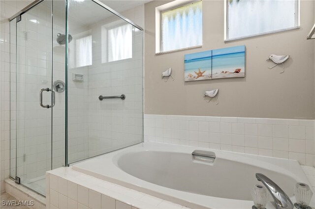 bathroom with shower with separate bathtub