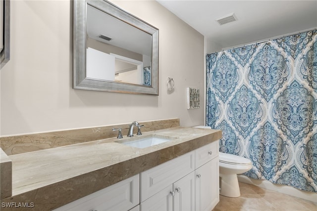 bathroom featuring tile patterned flooring, a shower with curtain, vanity, and toilet