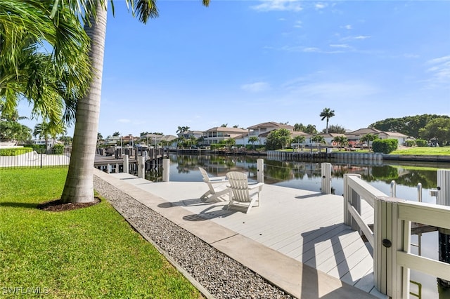 view of dock featuring a water view and a yard