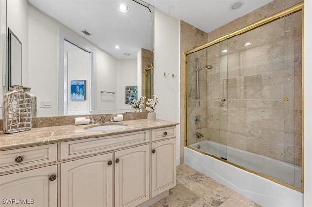 bathroom featuring enclosed tub / shower combo and vanity