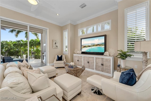 tiled living room with ornamental molding, ceiling fan, and a healthy amount of sunlight