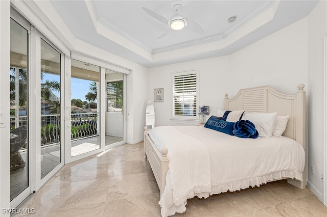 bedroom featuring ceiling fan, a tray ceiling, crown molding, and access to exterior