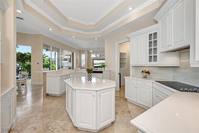 255 Mermaids Bight, Naples, FL 34103 - kitchen with decorative backsplash, glass insert cabinets, a center island, a peninsula, and black electric cooktop