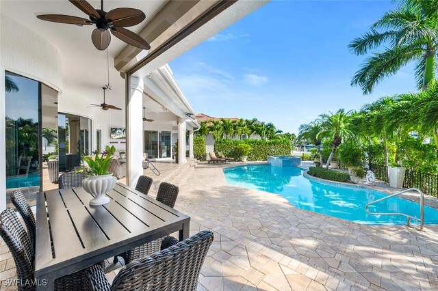 view of swimming pool with ceiling fan and a patio area