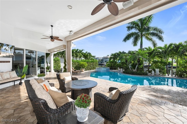 view of swimming pool with a patio, ceiling fan, and outdoor lounge area