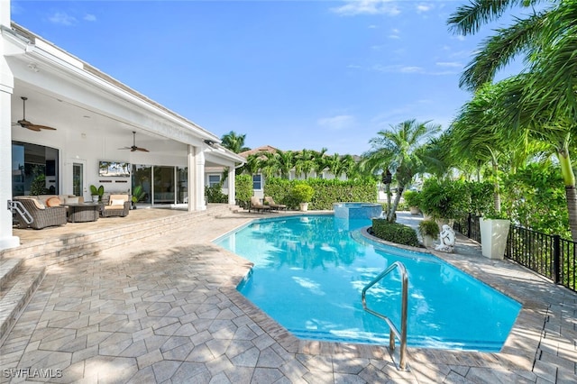 view of swimming pool with ceiling fan and a patio area