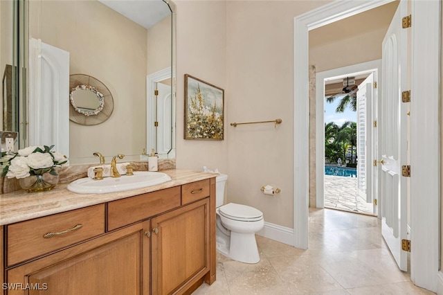 255 Mermaids Bight, Naples, FL 34103 - bathroom featuring vanity, toilet, a ceiling fan, and baseboards