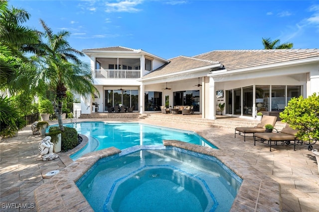 view of swimming pool featuring an in ground hot tub, ceiling fan, and a patio area