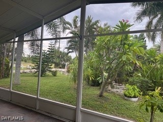 unfurnished sunroom featuring lofted ceiling