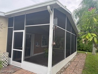 view of home's exterior with a sunroom