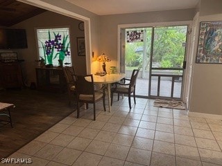 dining space featuring lofted ceiling and light hardwood / wood-style floors