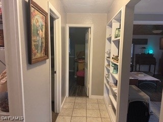 corridor featuring light tile patterned floors