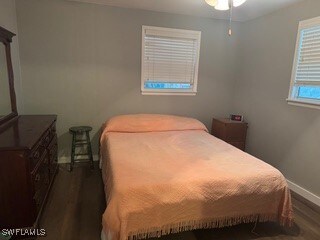 bedroom with dark hardwood / wood-style flooring