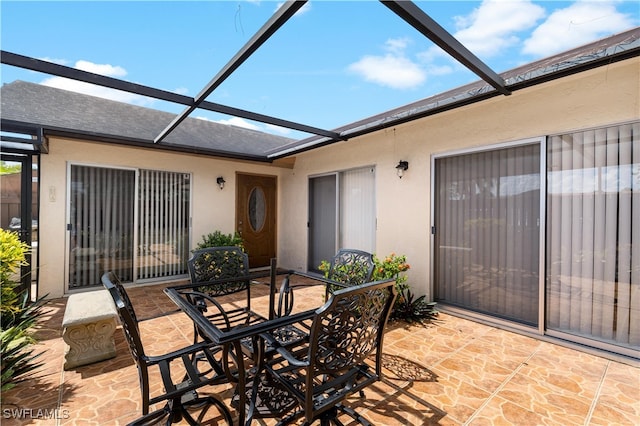 view of patio featuring a lanai