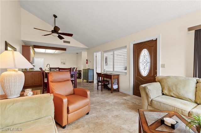 living room featuring vaulted ceiling, ceiling fan, and light tile patterned flooring