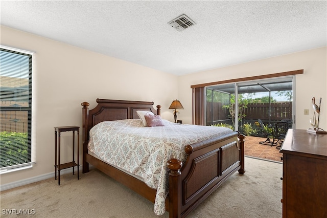 bedroom featuring multiple windows, light carpet, and access to exterior