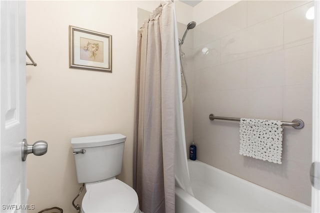 bathroom with shower / tub combo with curtain and toilet