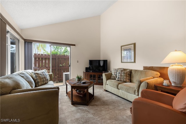 living room featuring high vaulted ceiling, a textured ceiling, and light tile patterned flooring