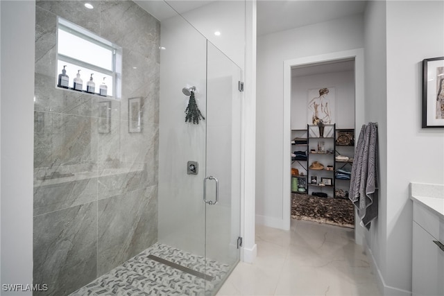 bathroom featuring walk in shower and vanity