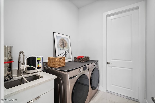 laundry area with light tile patterned floors, sink, and independent washer and dryer