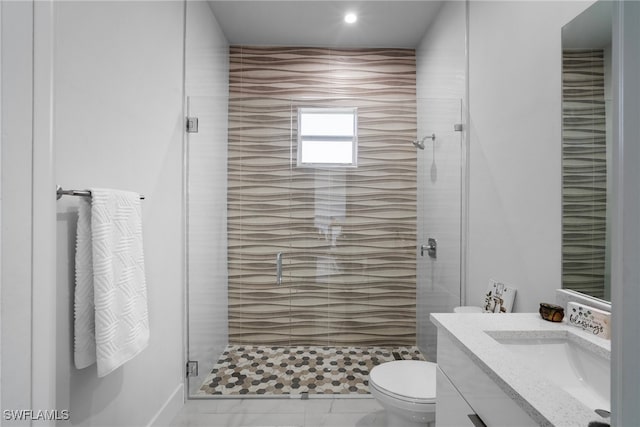 bathroom featuring walk in shower, vanity, and toilet