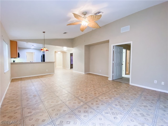 unfurnished living room featuring vaulted ceiling and ceiling fan