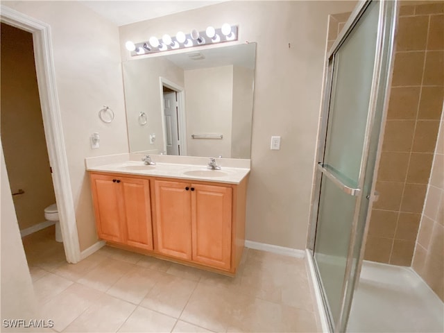 bathroom featuring walk in shower, tile patterned flooring, vanity, and toilet