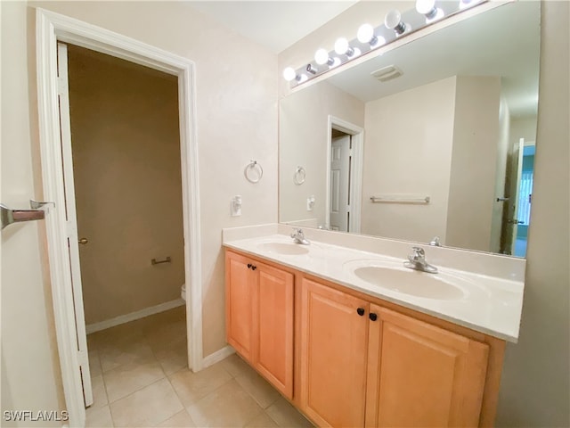 bathroom with tile patterned floors, vanity, and toilet