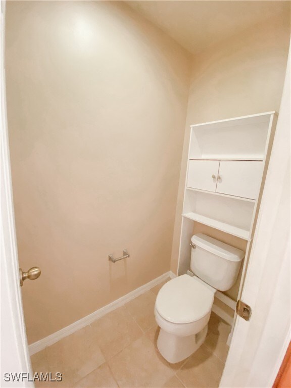 bathroom with tile patterned flooring and toilet