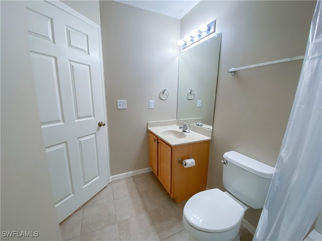 bathroom with tile patterned floors, vanity, and toilet