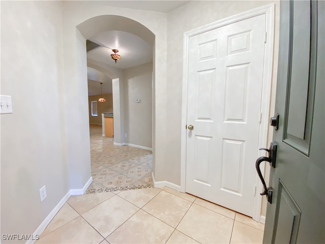 hall featuring light tile patterned flooring