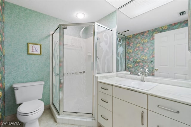 bathroom featuring walk in shower, vanity, toilet, and tile patterned floors