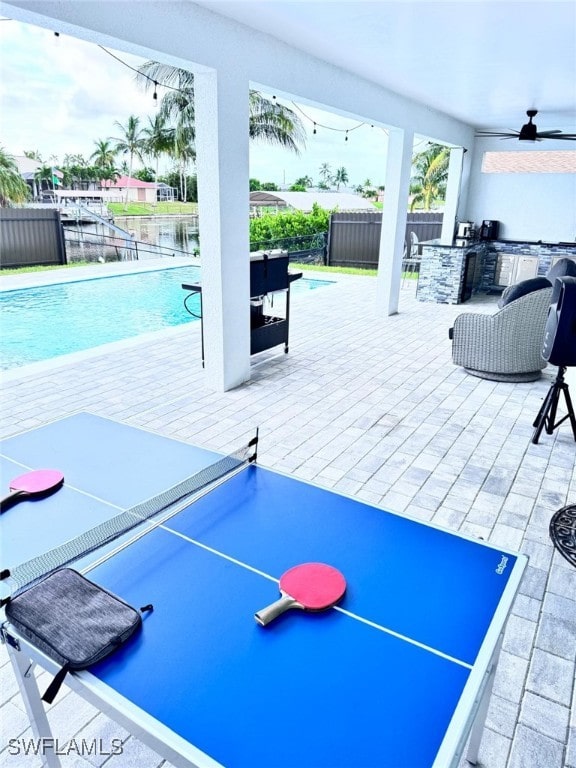 interior space featuring a fenced in pool and area for grilling