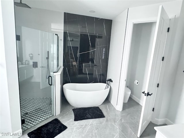 bathroom featuring shower with separate bathtub and toilet