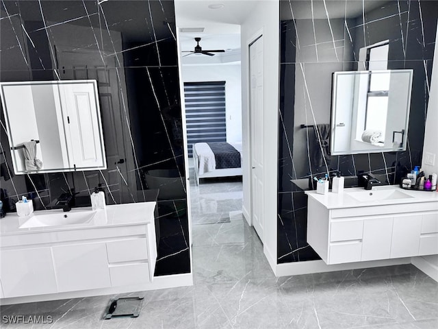 bathroom featuring tile walls, ceiling fan, and vanity