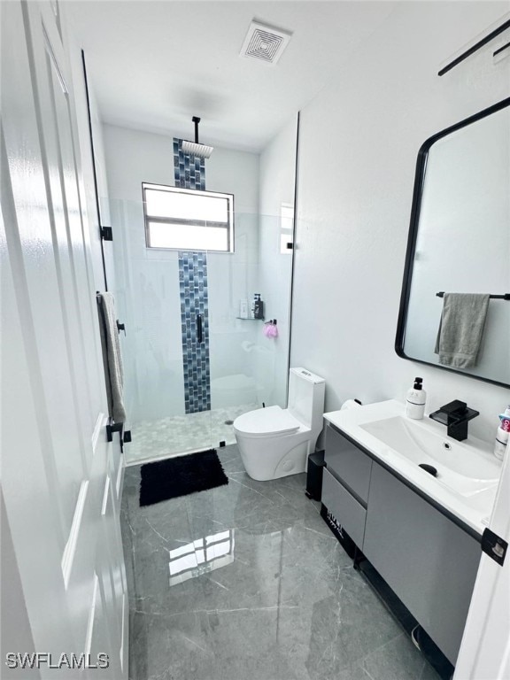 bathroom with walk in shower, vanity, and toilet