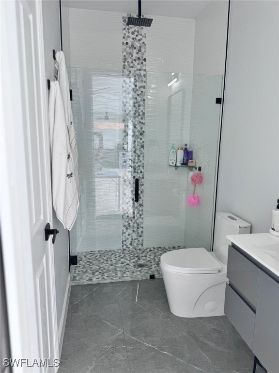 bathroom featuring vanity, toilet, and an enclosed shower