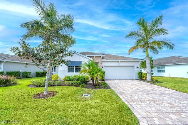 ranch-style house with an attached garage, decorative driveway, and a front yard