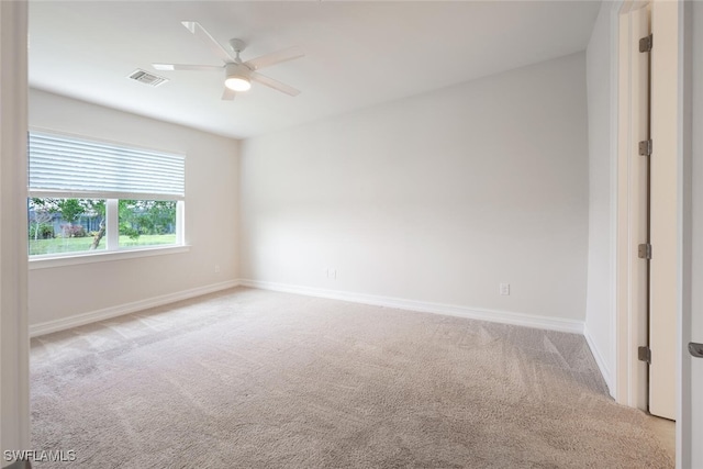 spare room featuring ceiling fan and light colored carpet