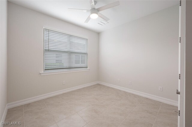 spare room featuring ceiling fan and light tile patterned flooring