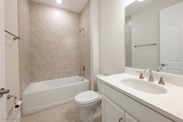 full bathroom with tile patterned floors, vanity, tiled shower / bath combo, and toilet